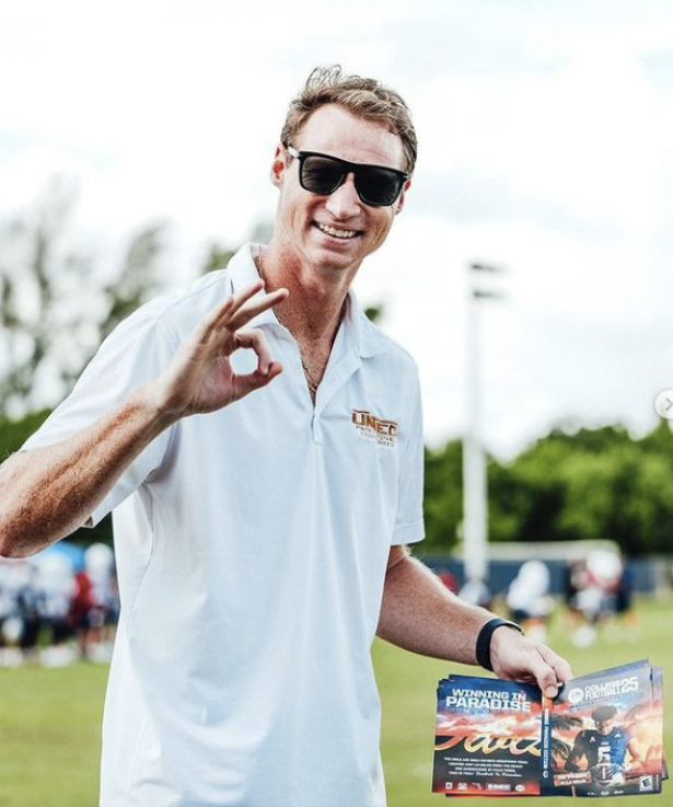 Founder and solo owner Bryan Rammel holding and posing with FAU’s personalized NCAA25 covers